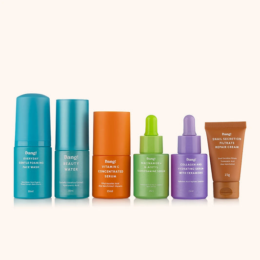 Set of skincare products including bottles and a cream on a white background