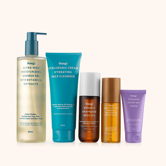 An image of multiple skincare products lined up behind a white background